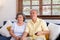 Asian couple senior sitting on sofa and use remote control to change channel and watching tv in living room at home