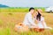 Asian couple smilling and enjoying eatting apple while sitting picnic in park