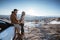 asian couple standing and enjoying the view of beautiful cappadocia in snow