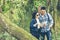 Asian couple traveler with backpack adventure holding map explore to find directions and walking relax in the jungle forest outdoo