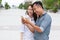 Asian couple using cell smart phone message smile