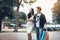 Asian couple walking at shopping mall looking product inside mirror retail