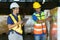 Asian couple warehouse workers checking shipment status on digital tablet computer prepare for delivery to customer. Employees