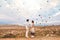 Asian couple watching colorful hot air balloons flying over the valley at Cappadocia, Turkey This Romantic time of love