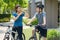 Asian couple wearing a helmet while preparing for a bike ride around her neighborhood for daily health and well being, both