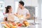 Asian couples feeding food together in kitchen. People and lifestyles concept. Sweet honeymoon and Holidays concept. Valentines