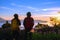 Asian couples Tourists with backpacks Standing watching landscape view on the mountain,Beautiful landscape And the light of the