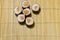 Asian cuisine sushi rolls maki with salmon raw fish home made food photography objects on wooden carpet background on table