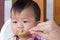 Asian cute baby boring eat food.