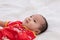 Asian cute baby boy Chinese Cheongsam costume toddler lie down on bed at home smiling laughing good humored  infant Chinese