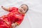Asian cute baby boy Chinese Cheongsam costume toddler lie down on bed at home smiling laughing good humored  infant Chinese