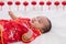 Asian cute baby boy Chinese Cheongsam costume toddler lie down on bed at home smiling laughing good humored  infant Chinese boy