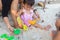 Asian cute baby girl and parent playing sand beach.