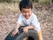 Asian cute child boy running auto car tire wheel with smiling face.