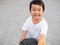 Asian cute child boy running auto car tire wheel with smiling face.