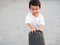 Asian cute child boy running auto car tire wheel with smiling face.