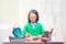 Asian cute girl in glasses learning with school stationary on the desk