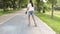 Asian cute girl playing roller blades on the road at public park.