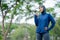 Asian cute muslim woman wearing sportswear and a blue hijab doing exercise and being tired and drinking water