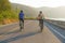 Asian cyclist couple riding together for exercise around the lake in the morning with beautiful mountain view in the background