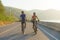 Asian cyclist couple riding together for exercise around the lake in the morning with beautiful mountain view in the background