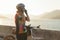 Asian cyclist woman wearing sunglasses getting ready for morning bike ride around the lake with beautiful mountain view in the bac