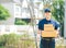 Asian deliver man in blue uniform holding package box