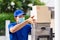 Asian deliver man make contactless package delivery to customer