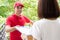 Asian delivery man giving clipboard to a woman to sign