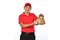 Asian delivery man in red uniform carry bags of food and drink in hands