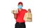 Asian delivery man in red uniform, medical face mask carry bags of food and drink in hands isolated on white background