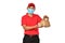 Asian delivery man in red uniform, medical face mask carry bags of food and drink in hands isolated on white background