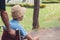 Asian disabled child on wheelchair wearing a hat in the sheep farm