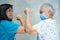 Asian doctor and elder patient bump elbows for new normal to social distancing avoid covid-19 coronavirus