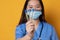 Asian doctor with mask showing three laboratory samples in transparent tubes