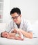 Asian doctor and newborn baby on the clinic , monitoring heart r