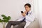 Asian Doctor or Physician Thinking and Use Smartphone in Office