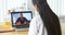 Asian doctor video chatting with African patient