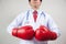Asian Doctor wearing boxing gloves in white background