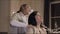 Asian doula massaging pregnant woman at home