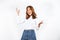 Asian dyed brown-haired girl in white sweater dancing with hands up and inspired face expression in white background