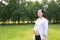 Asian Eastern Chinese happy pregnant woman hands on belly expecting baby to born be a good mother enjoy nature outdoor time