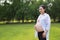 Asian Eastern Chinese happy pregnant woman hands on belly expecting baby to born be a good mother enjoy nature outdoor time