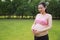 Asian Eastern Chinese happy pregnant woman hands with love gesture on belly care about new-born baby expect child to born love