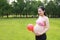 Asian Eastern Chinese happy pregnant woman in yoga dress hands hold her belly expecting baby to born balloon beside love hope