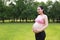 Asian Eastern Chinese happy pregnant woman in yoga dress hands hold her belly expecting baby to born parents mother love concept