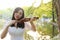 Asian Eastern Chinese young artist woman play violin by river in a park garden outdoor nature sunset sunrise day musical art