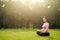 Asian Eastern Chinese young pretty pregnant girl woman do yoga sit in meditation, do lotus gesture of yoga outdoor nature sunset