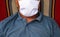 Asian elder man wearing white fabric mask while lying