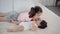Asian elder sister kissing cheek newborn baby while baby crying, Adorable girl comforting younger brother after toddler wake up an